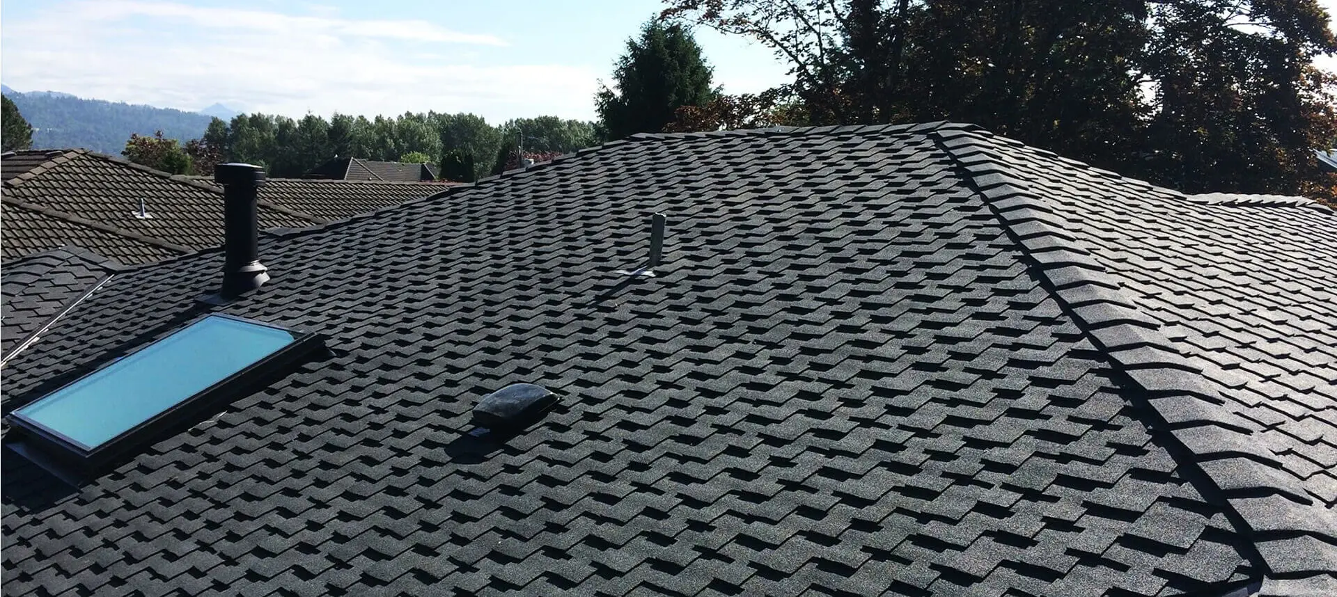 A black roof with a vent and a camera