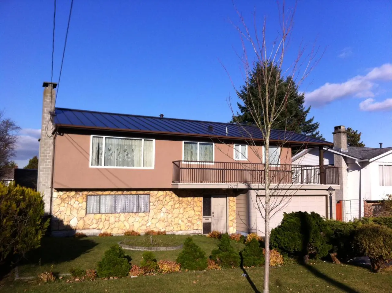 A house with a solar panel on the roof.